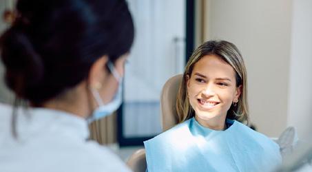Smiling patient interacting with dental team member