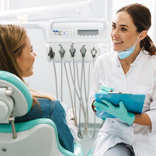 A woman consulting her dentist about a smile makeover treatment