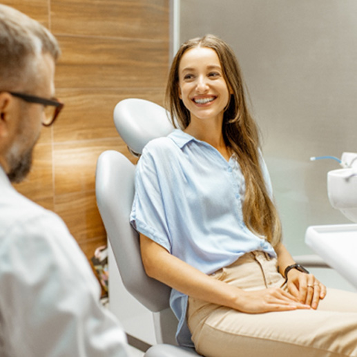 a woman speaking with her dentist about dental implants
