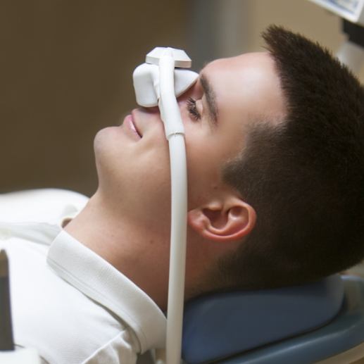 Dental patient receiving nitrous oxide sedation dentistry treatment