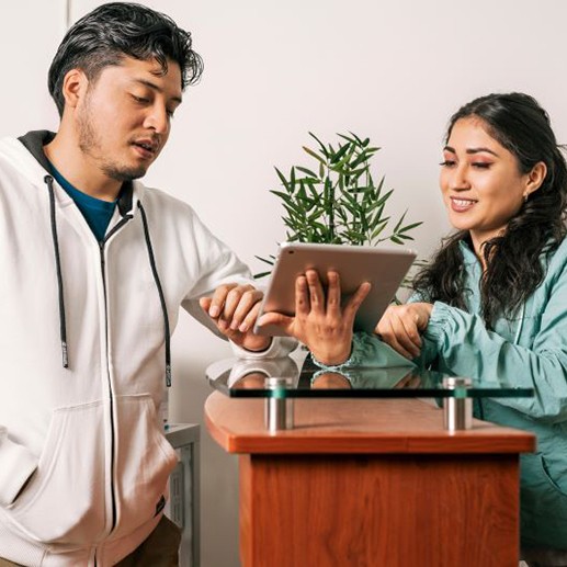 Dental team member assisting a patient at front desk