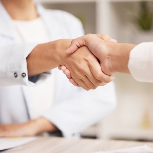 Dentist and patient shaking hands