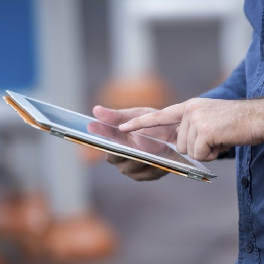 Dental patient reviewing the cost of dental implants on tablet computer