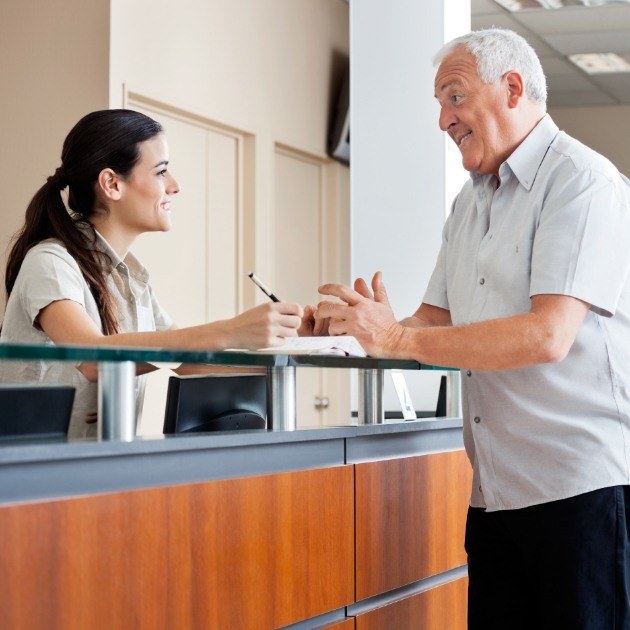 Dentistry team member explaining dental insurance coverage to dental patient