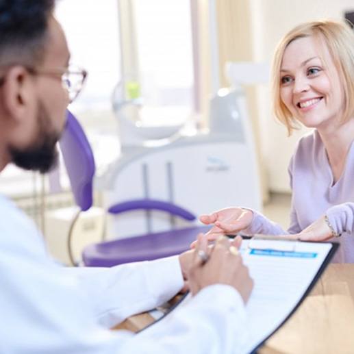 a patient talking to her dentist about insurance