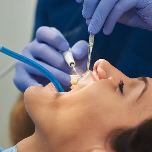 Dentist providing scaling and root planing treatment