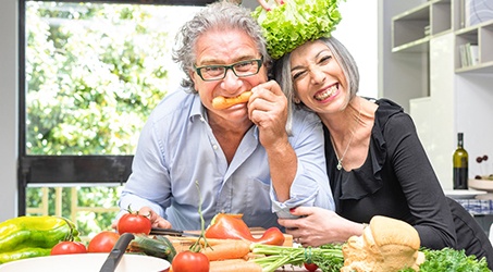 A woman pointing out her new dental implant