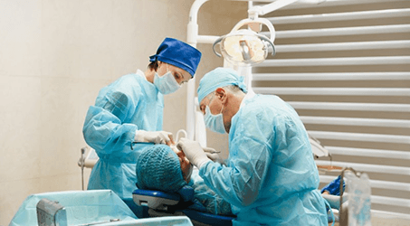 an oral surgeon placing dental implants for a patient