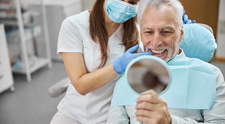 An aging gentleman happy with his dental implant’s final restoration