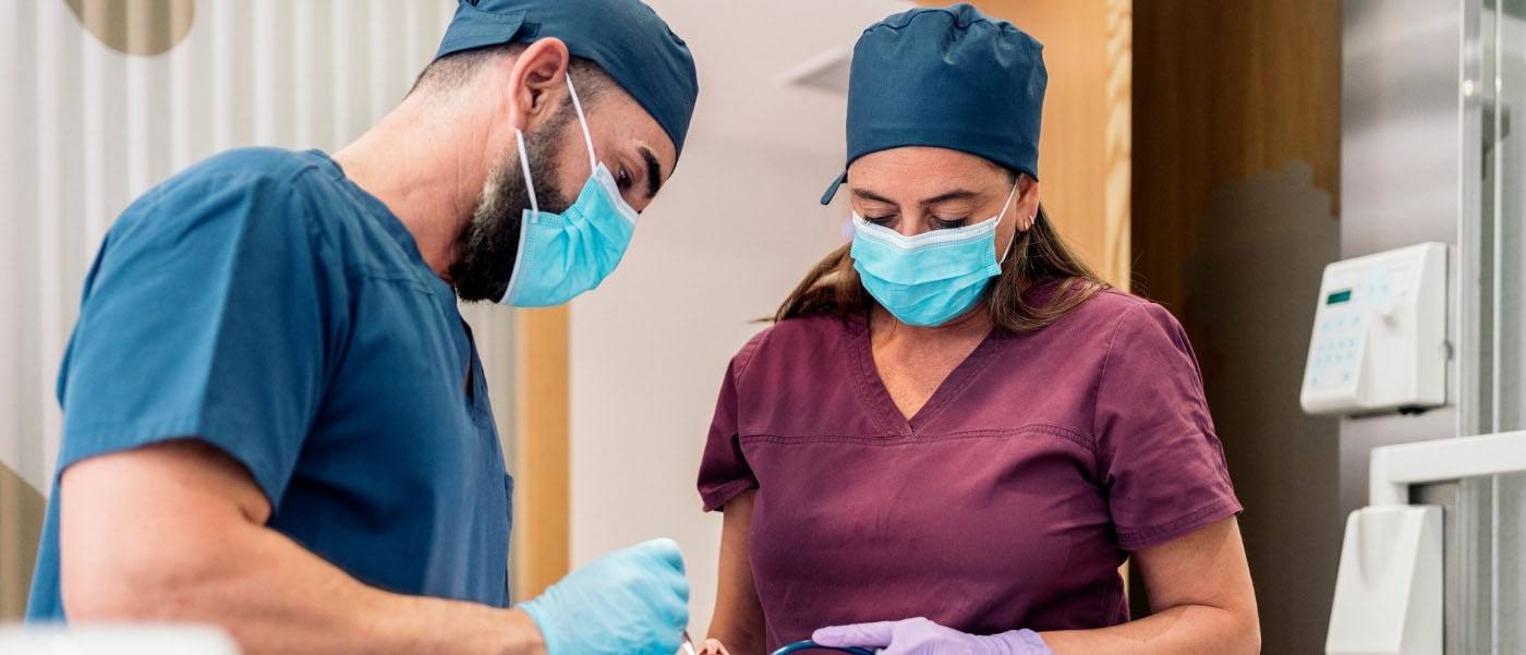 Dentist and dentistry team member treating dental patient