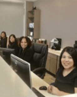 Four smiling dentistry team members in Springdale dental office