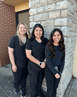 Four smiling dentistry team members in Springdale dental office