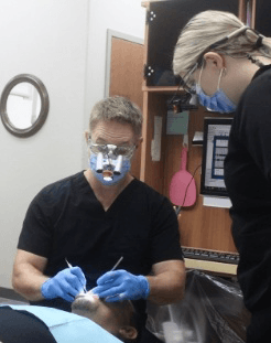 Springdale dentist and dental team member treating dentistry patient