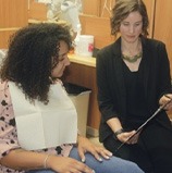 Dental team member showing clipboard to Springdale dental patient