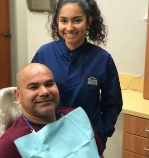 Springdale dental team member and dental patient smiling