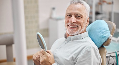 Man with straight teeth smiling in treatment chair