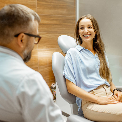 Woman smiling during Invisalign consultation with Springdale dentist