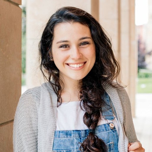 a teen smiling after undergoing Invisalign treatment