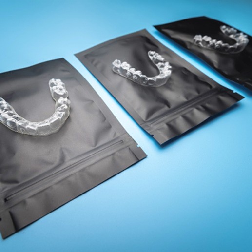 Invisalign aligners on black bags