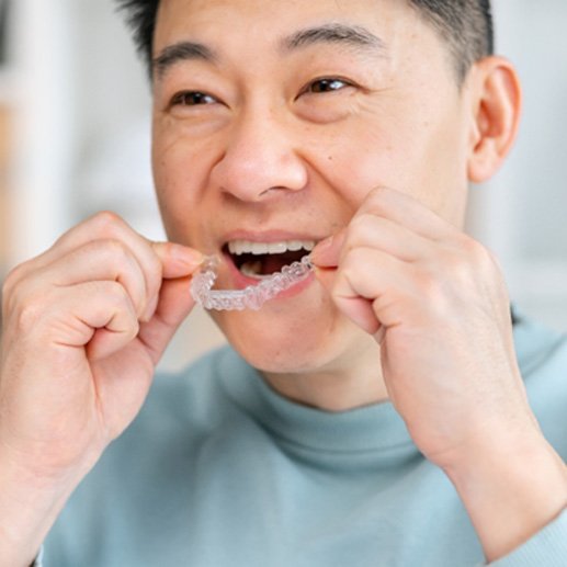 Man putting in Invisalign aligner