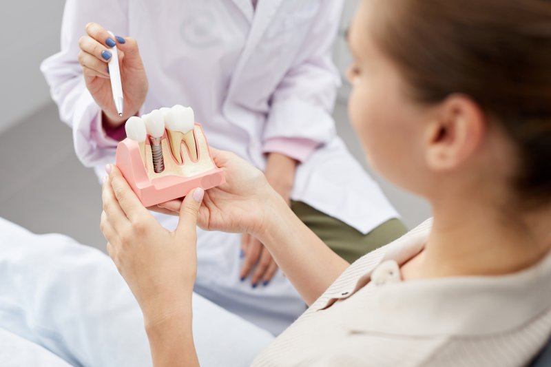 A dentist explaining dental implant care to a patient