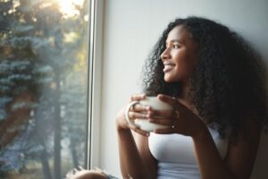 Woman smiling and drinking coffee