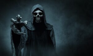 Scary, hooded skeleton reaching hand out.